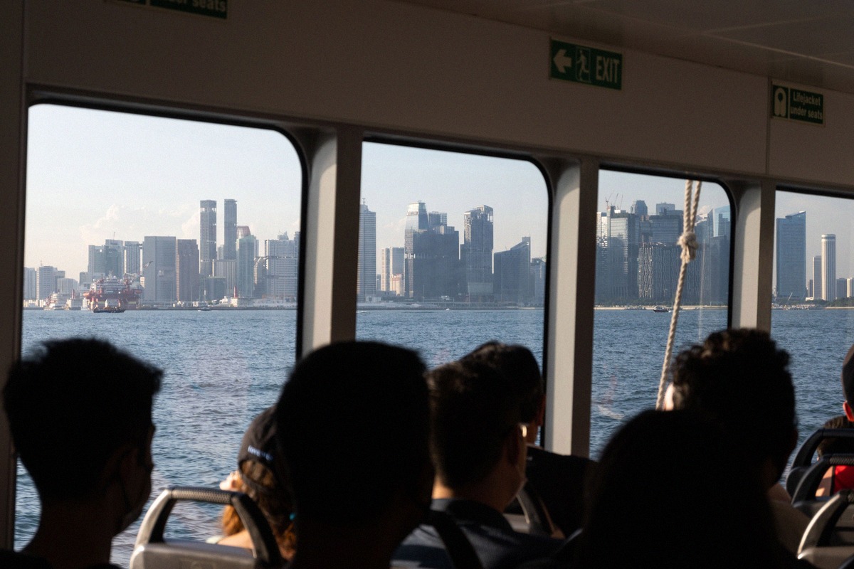 Passengers on the ferry from St John's Island looking out at Singapore's skyline